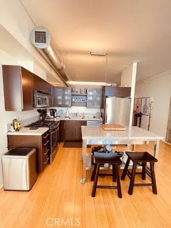 a kitchen with a table chairs microwave and cabinets