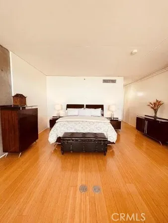 a bedroom with a bed and dresser