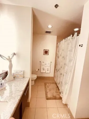 a bathroom with a granite countertop sink a mirror and a shower