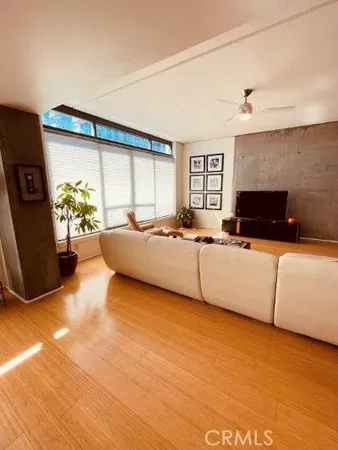 a living room with furniture and large window