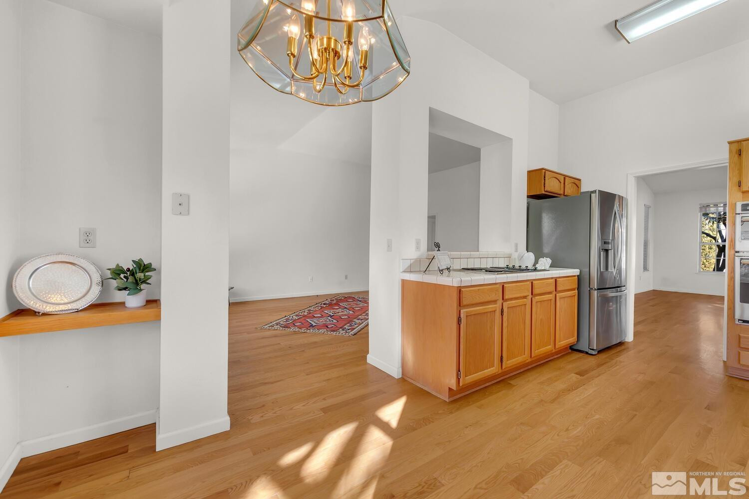 195 Riverbrook Court Reno, NV 89519 - Photo 13 of 40 a view of a kitchen with a sink dishwasher stove and wooden floor