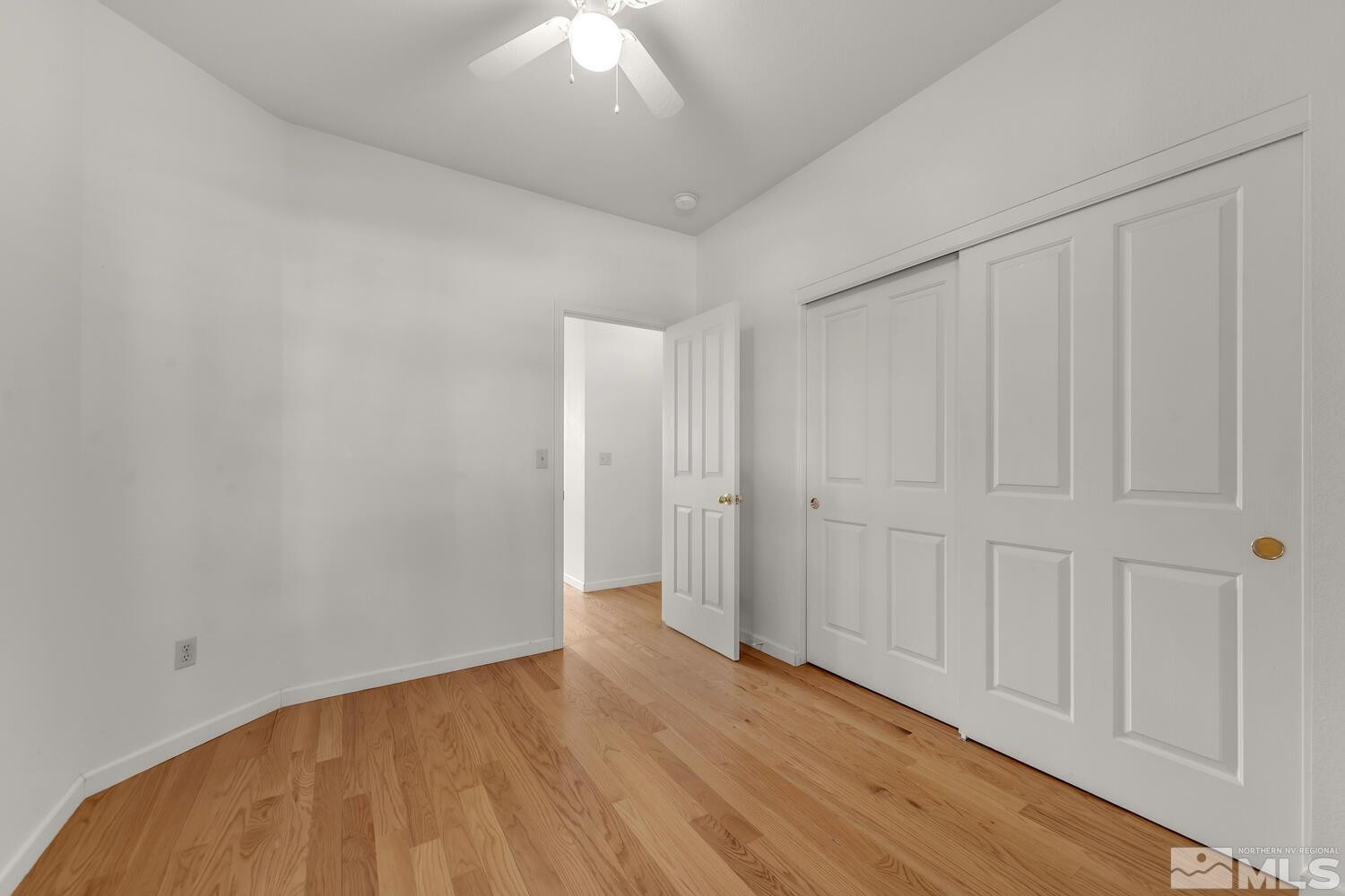 195 Riverbrook Court Reno, NV 89519 - Photo 31 of 40 a view of an empty room with wooden floor