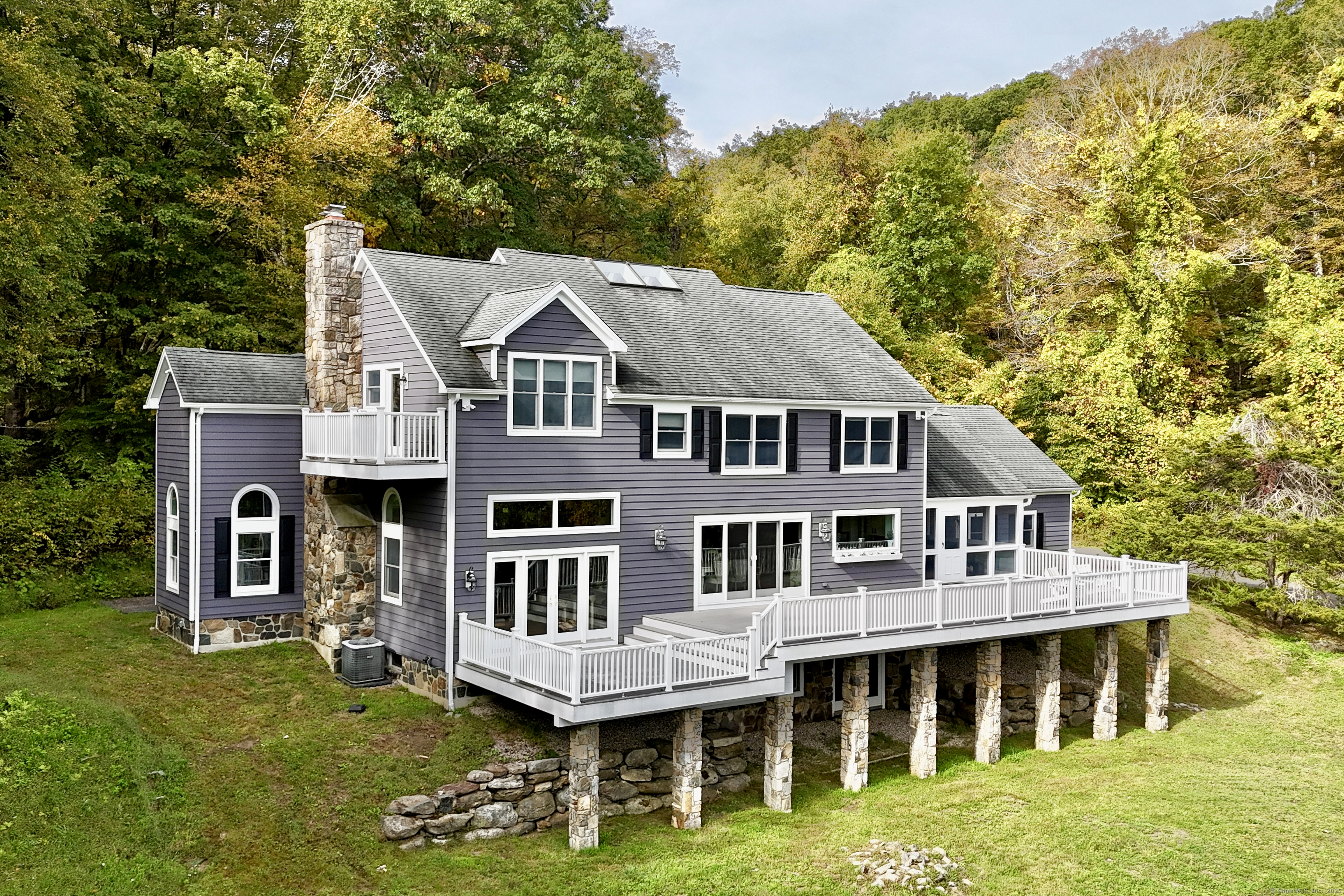 a aerial view of a house with swimming pool next to a yard