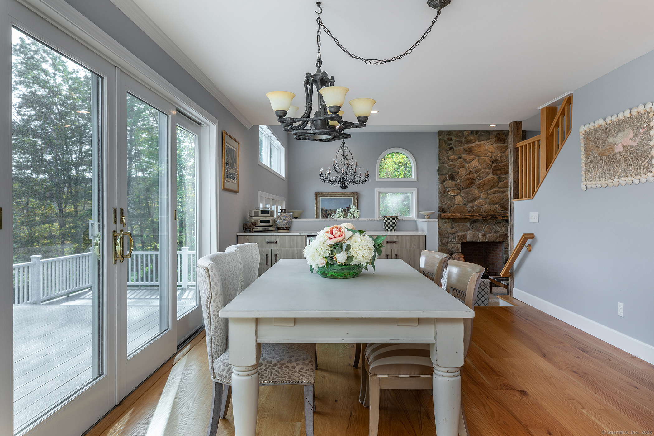 168 Cobble Road Kent, CT 06757 - Photo 19 of 40 a view of a dining room with furniture a chandelier and wooden floor