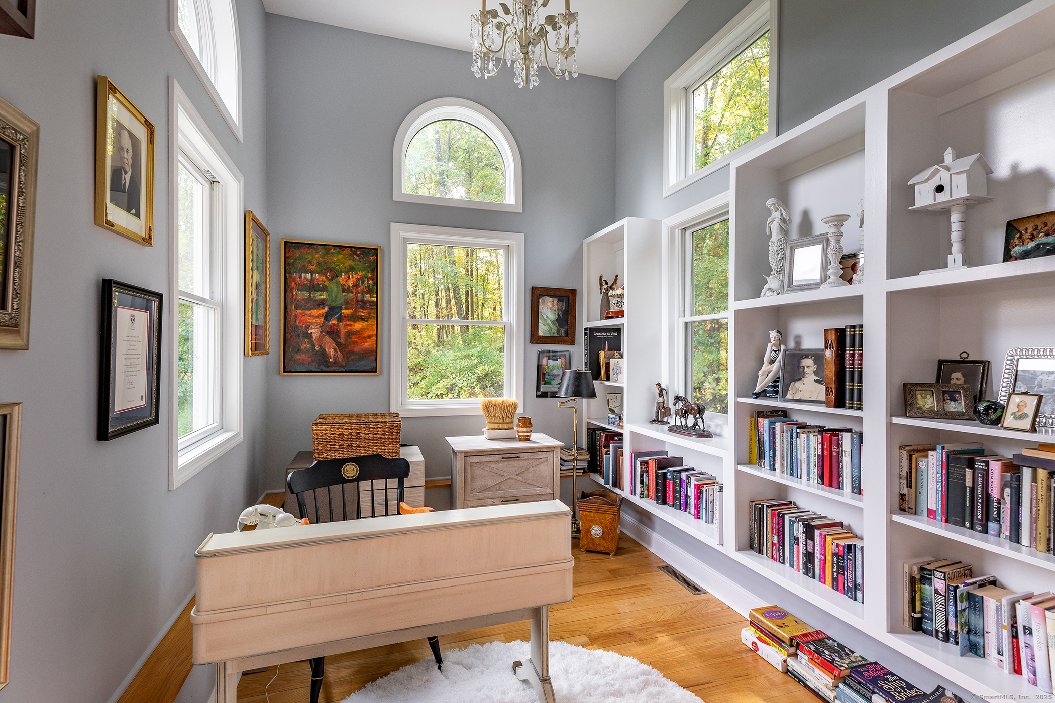 168 Cobble Road Kent, CT 06757 - Photo 25 of 40 a living room with fireplace furniture and a book shelf
