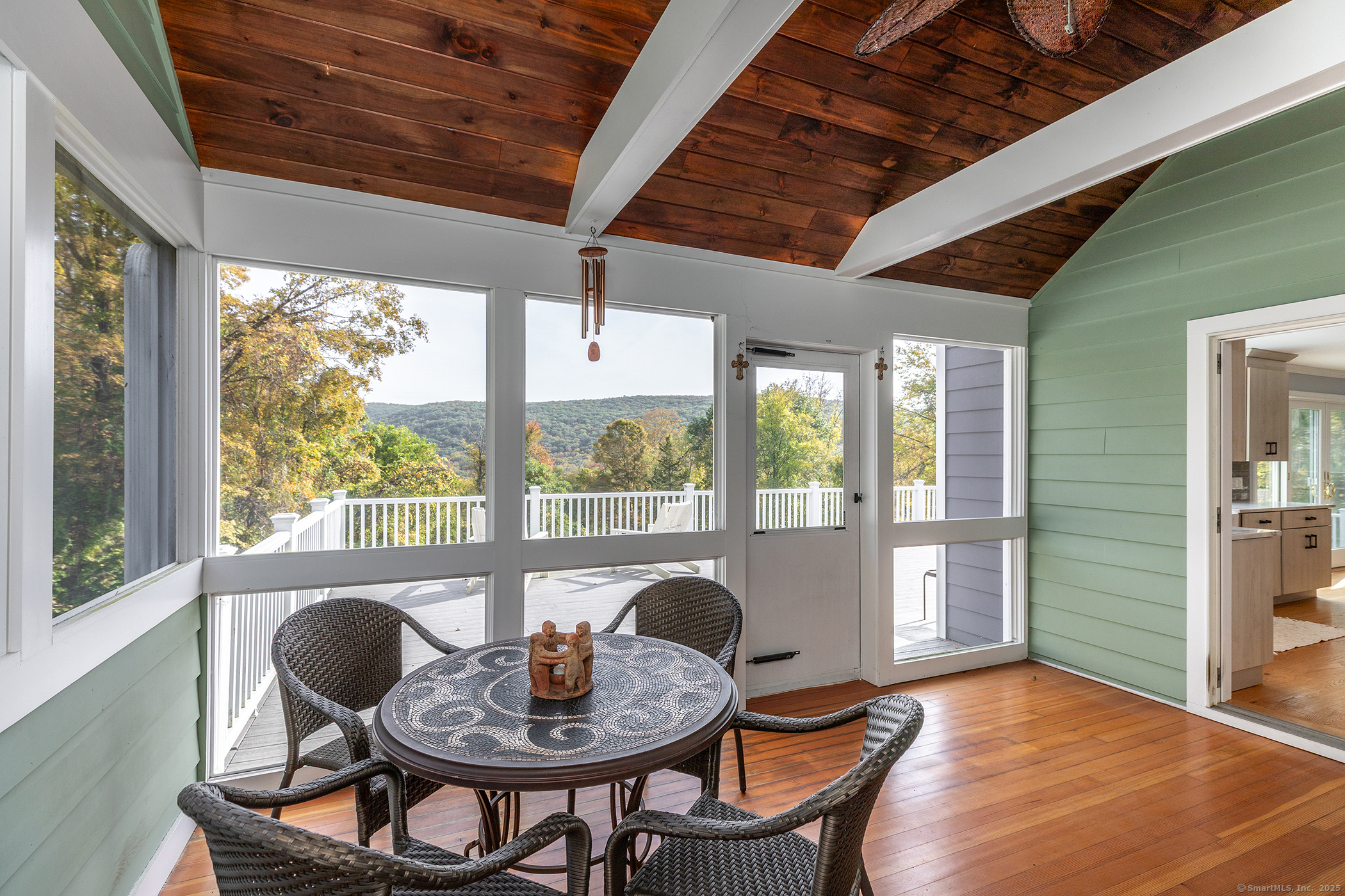 168 Cobble Road Kent, CT 06757 - Photo 8 of 40 a dining room with furniture wooden floor and a potted plant