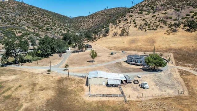 a white house with a yard and wooden fence