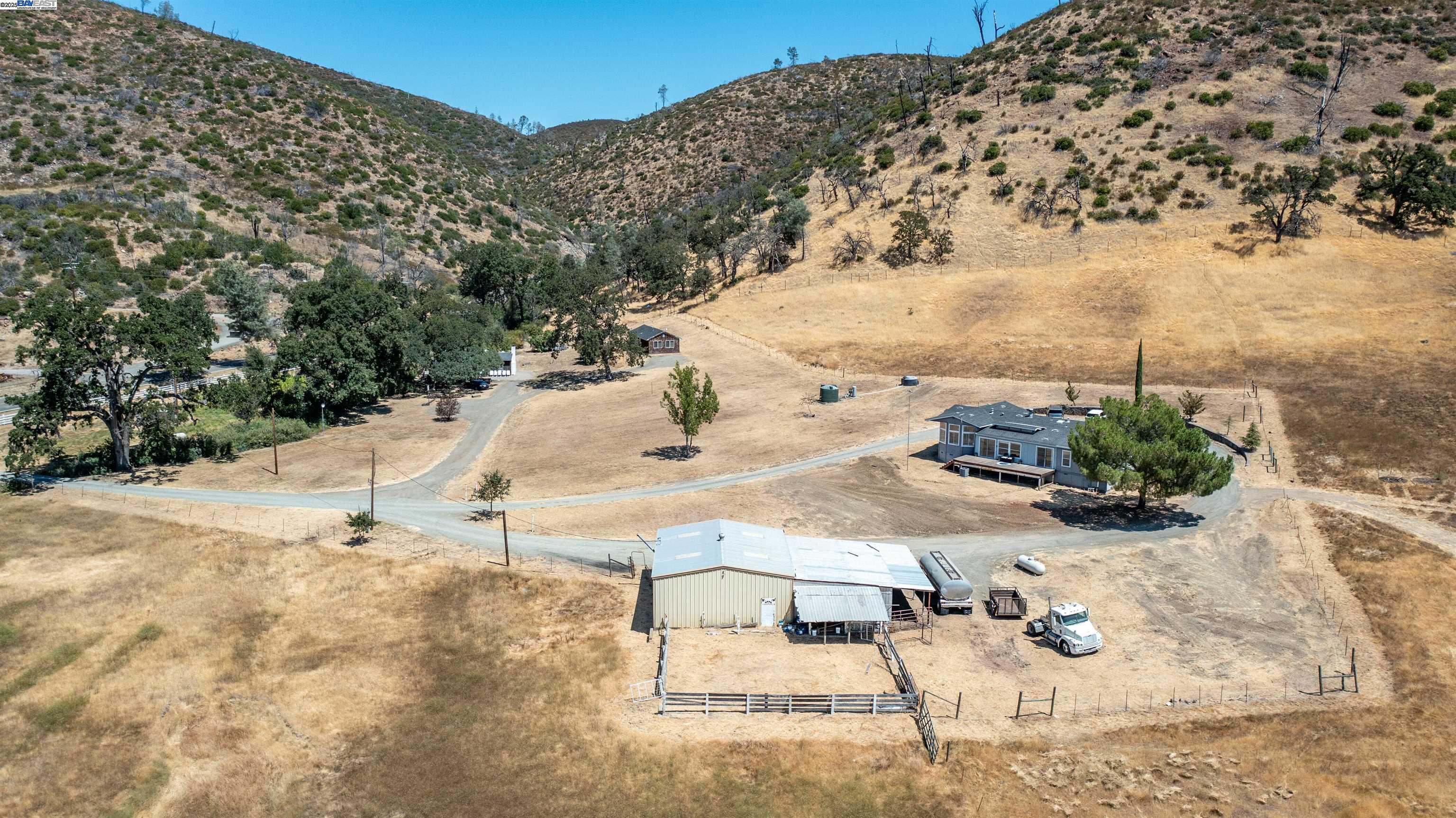 7878 Butts Canyon Road Pope Valley, CA 94567 - Photo 20 of 28 a white house with a yard and wooden fence