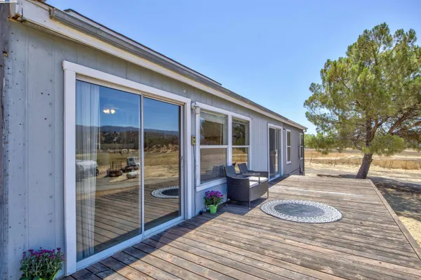 a front view of a house with outdoor seating