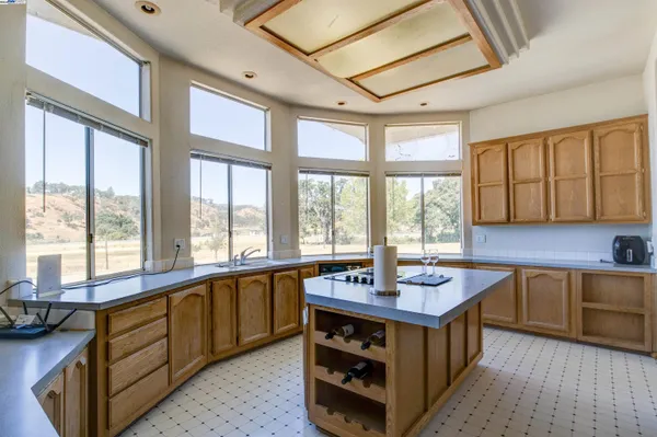a kitchen with stainless steel appliances granite countertop a sink and a stove