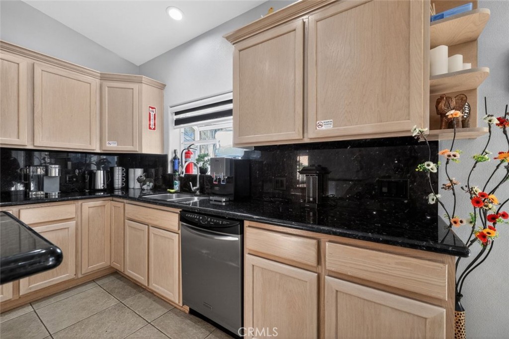 67972 Monterico Road Desert Hot Springs, CA 92240 - Photo 13 of 30 a kitchen with stainless steel appliances granite countertop a sink and cabinets