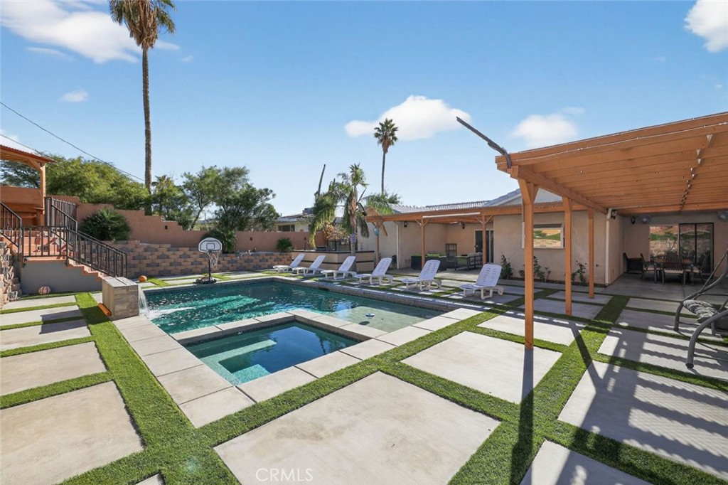 67972 Monterico Road Desert Hot Springs, CA 92240 - Photo 14 of 30 a view of a house with backyard swimming pool and sitting area
