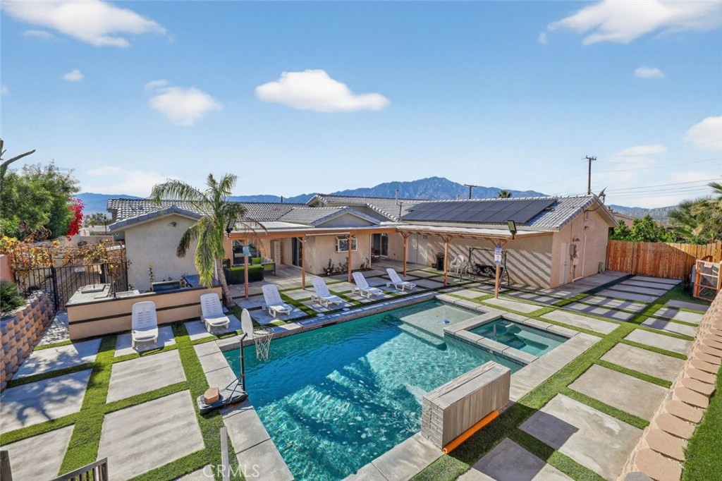 67972 Monterico Road Desert Hot Springs, CA 92240 - Photo 15 of 30 a view of house with pool and outdoor seating