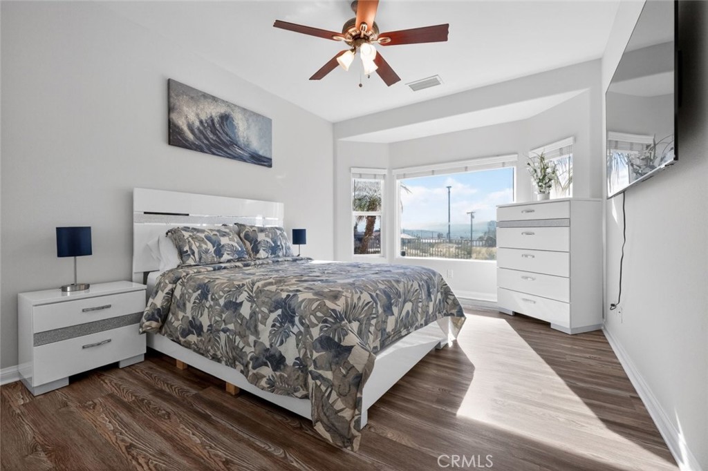 67972 Monterico Road Desert Hot Springs, CA 92240 - Photo 22 of 30 a bedroom with a bed and a flat tv screen on dresser