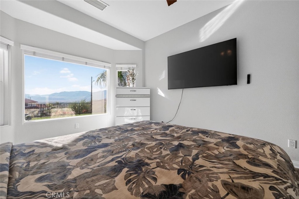 67972 Monterico Road Desert Hot Springs, CA 92240 - Photo 23 of 30 a bedroom with a bed and a flat screen tv