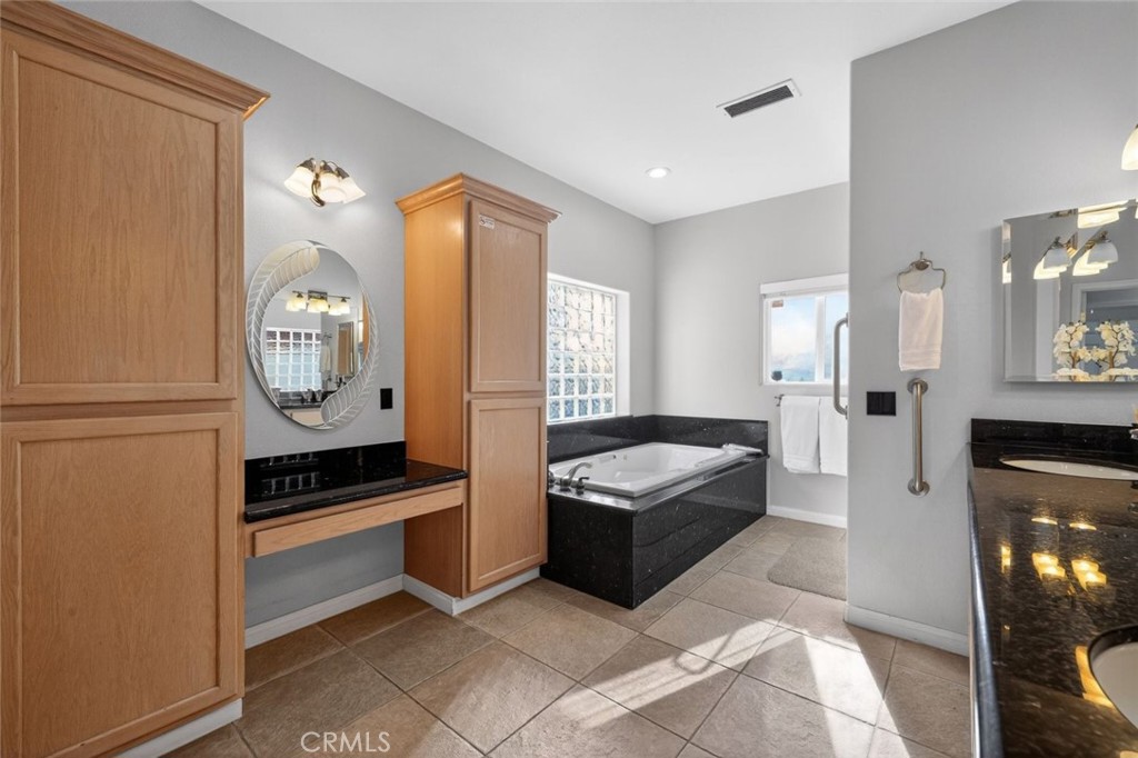 67972 Monterico Road Desert Hot Springs, CA 92240 - Photo 26 of 30 a spacious bathroom with a tub a mirror and a shower