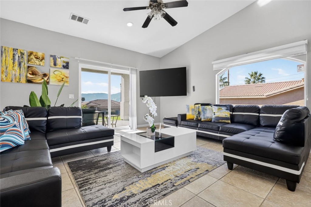 67972 Monterico Road Desert Hot Springs, CA 92240 - Photo 9 of 30 a living room with furniture and a flat screen tv