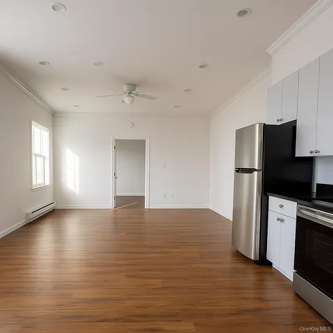 a view of a kitchen with a sink and a refrigerator