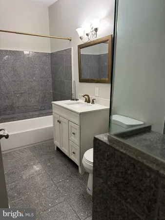 a bathroom with a sink a toilet and mirror