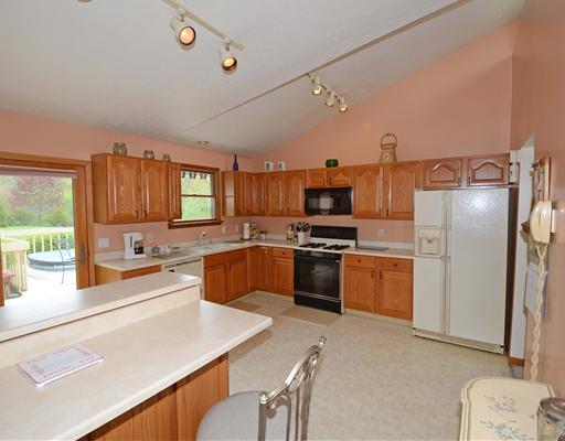 221 Monks Road Valencia, PA 16059 - Photo 2 of 18 Kitchen. Spacious kitchen with oak cabinets, gas stove, dishwasher, refrigerator, microwave, breakfast peninsula, vaulted ciling, trak lighting, patio doors to deck.