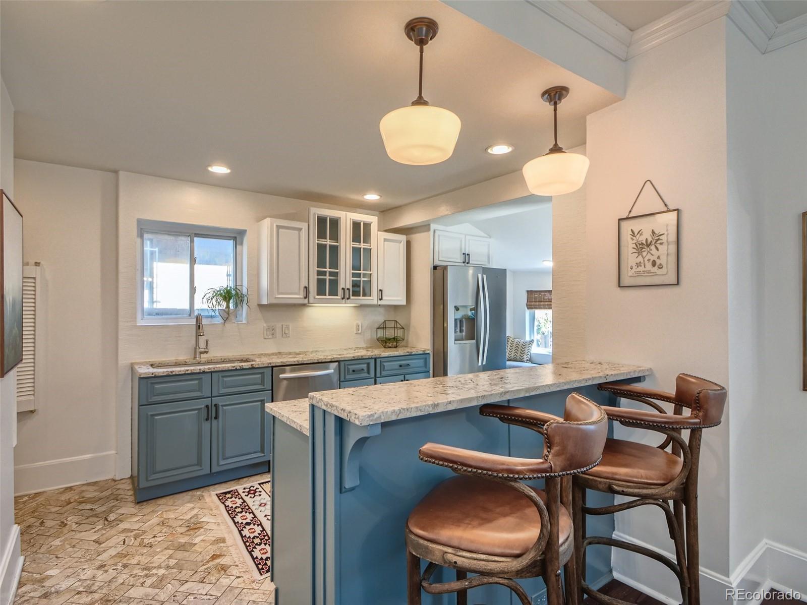 2958 Hooker Street Denver, CO 80211 - Photo 12 of 40 a kitchen with a dining table and chairs