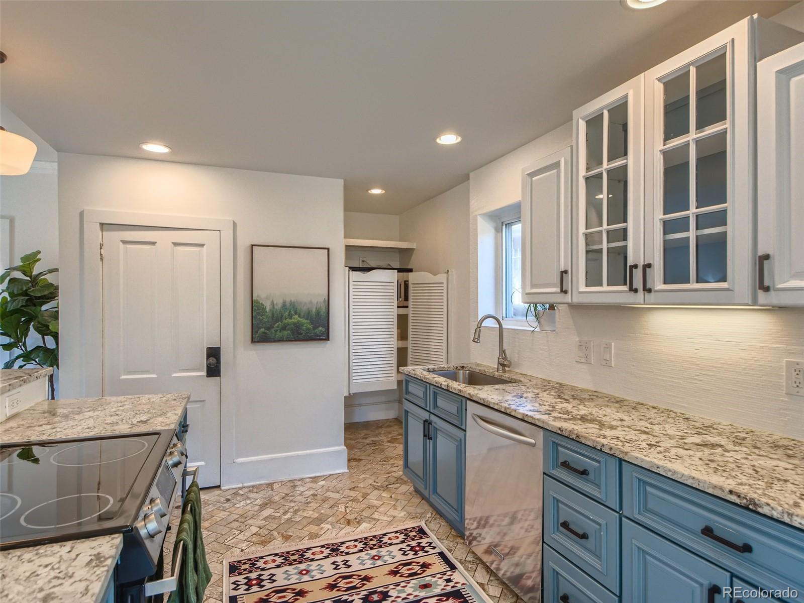 2958 Hooker Street Denver, CO 80211 - Photo 14 of 40 a kitchen with a sink refrigerator and microwave