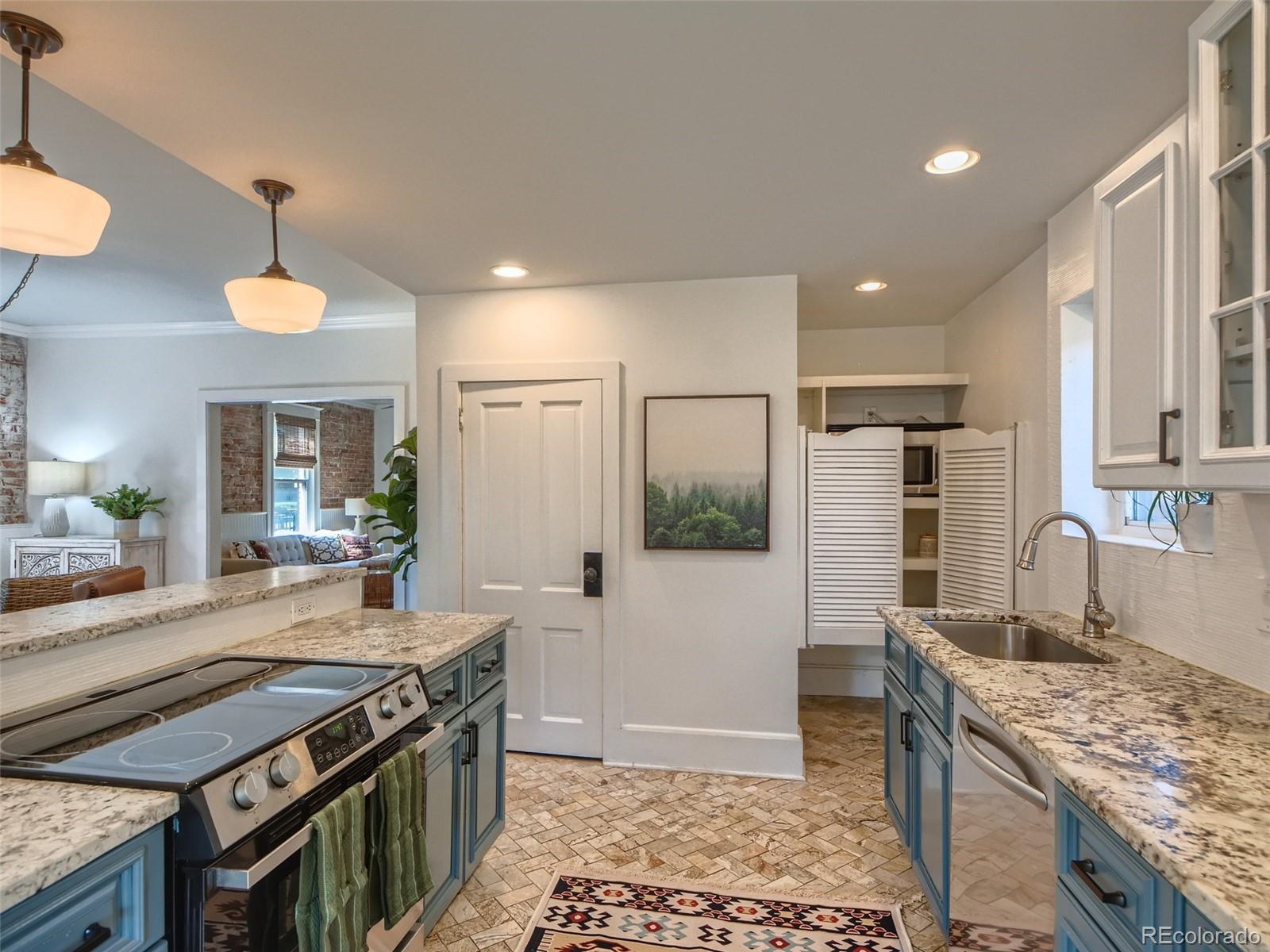 2958 Hooker Street Denver, CO 80211 - Photo 16 of 40 a kitchen with stainless steel appliances granite countertop a stove a sink and a refrigerator