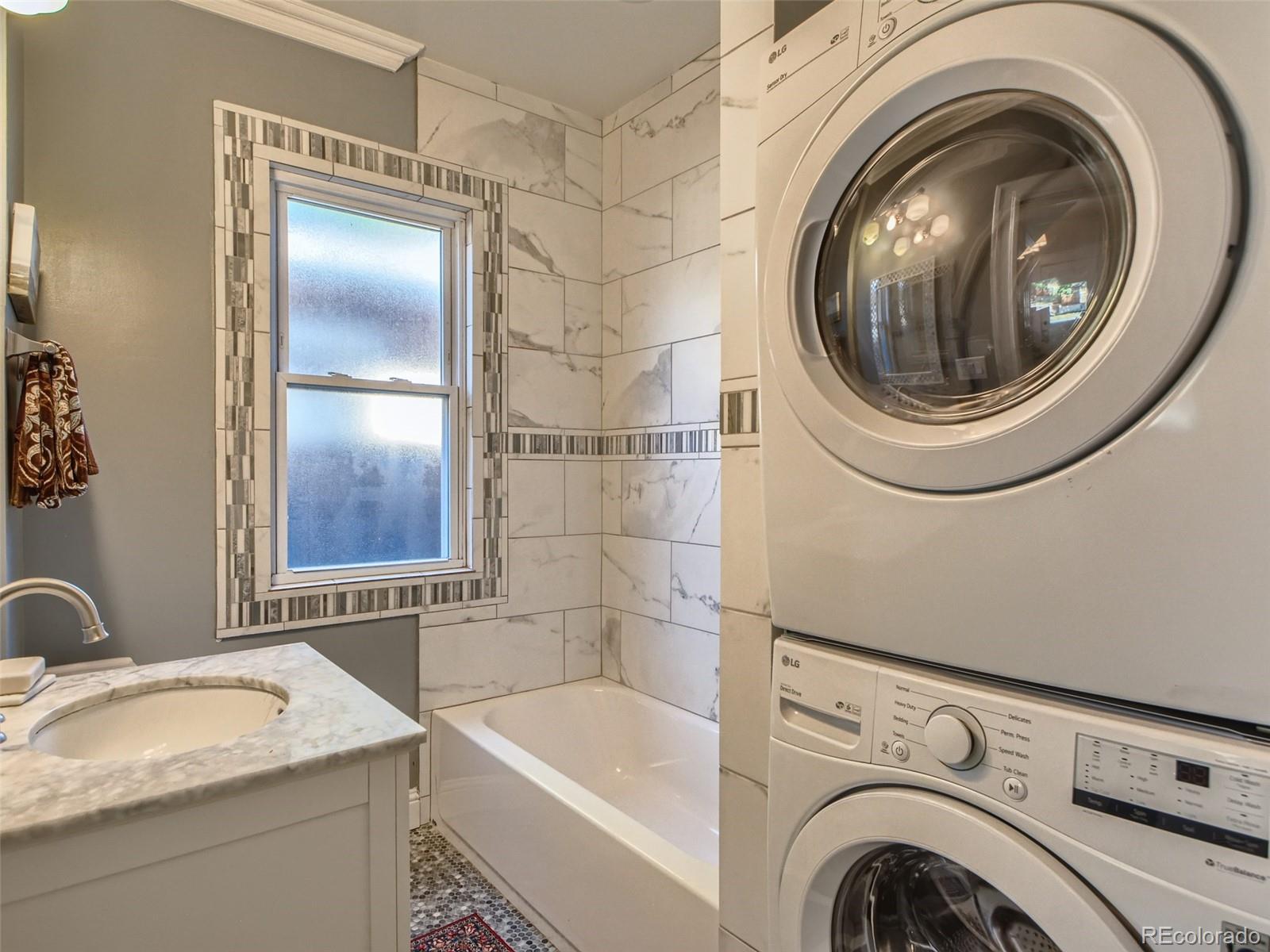 2958 Hooker Street Denver, CO 80211 - Photo 18 of 40 a bathroom with a granite countertop sink and a mirror