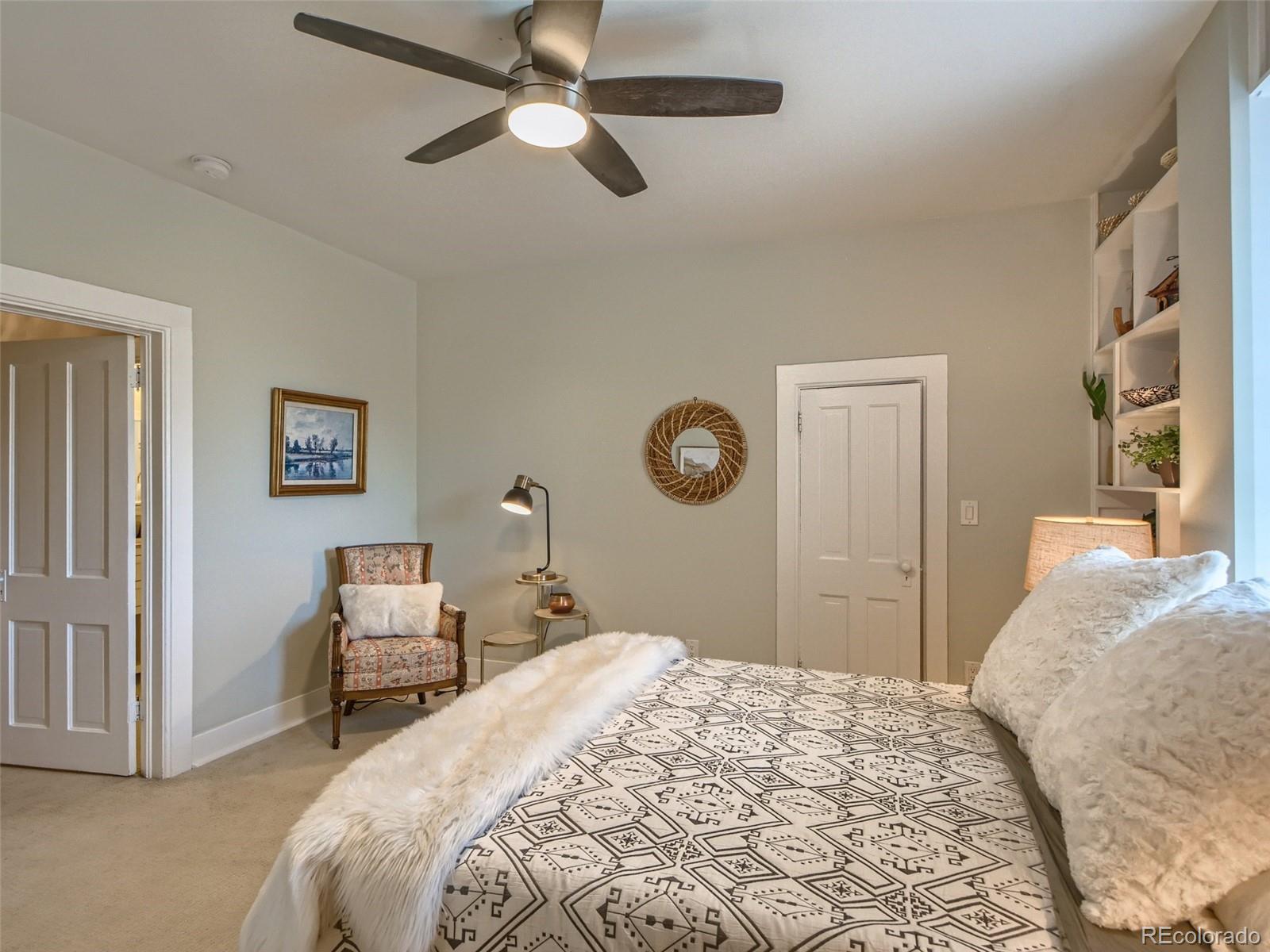 2958 Hooker Street Denver, CO 80211 - Photo 22 of 40 a bedroom with a bed and a chandelier