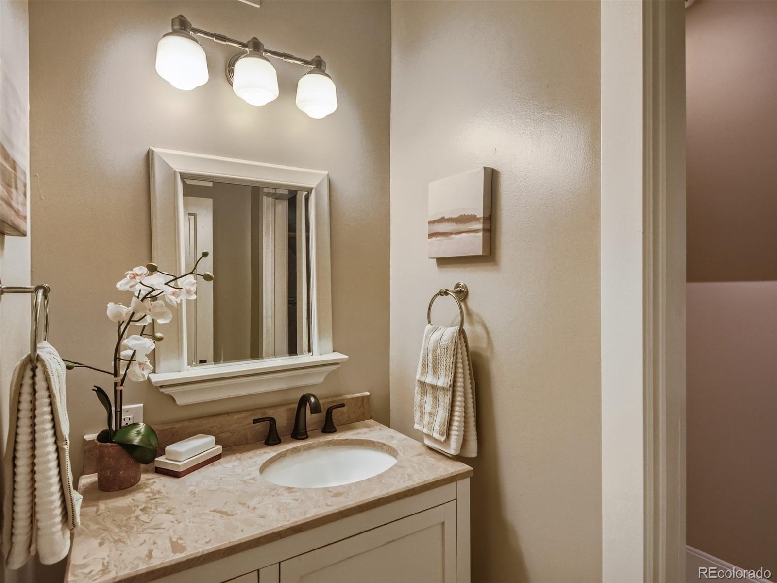 2958 Hooker Street Denver, CO 80211 - Photo 24 of 40 a bathroom with a sink and a mirror
