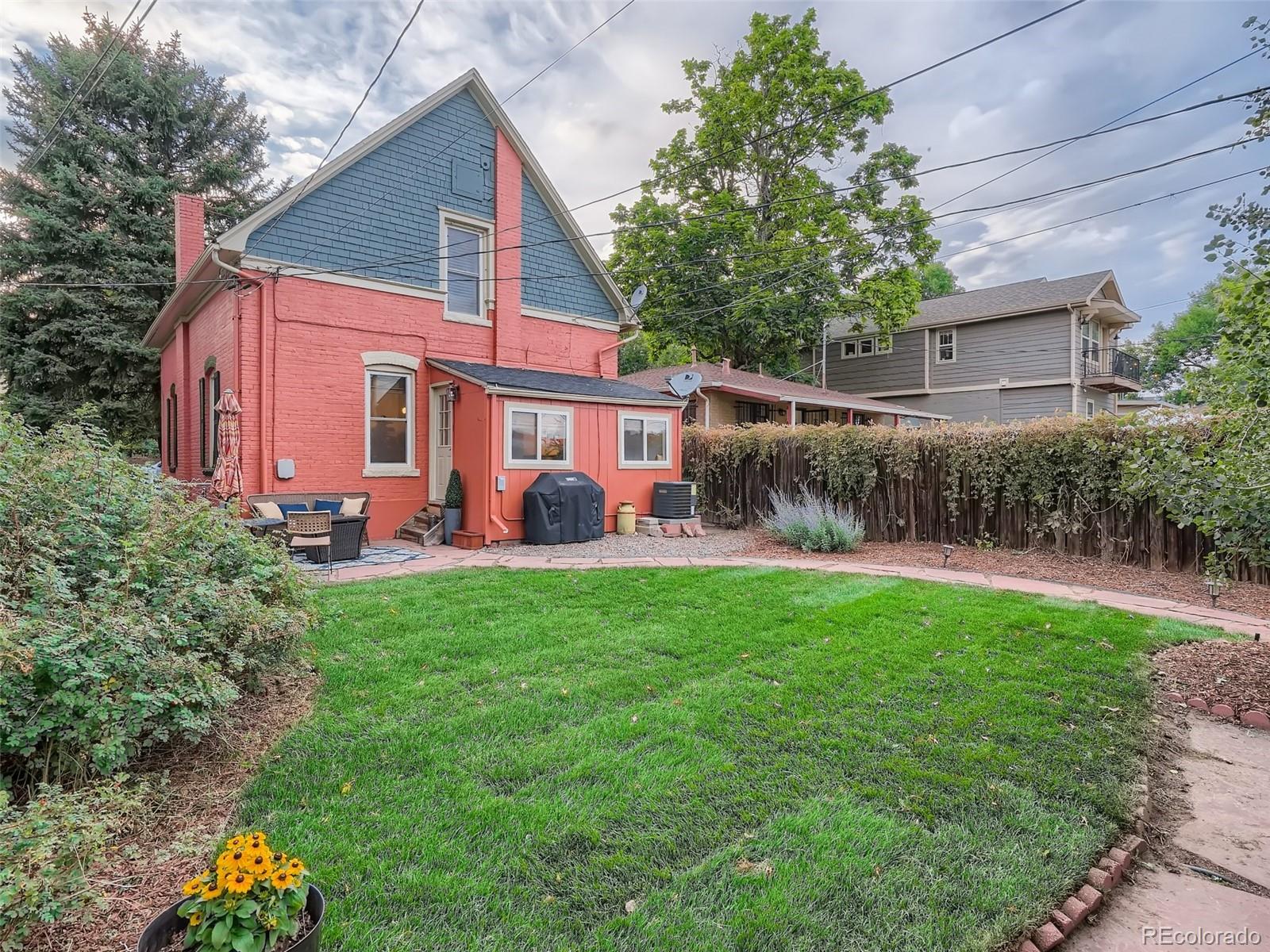 2958 Hooker Street Denver, CO 80211 - Photo 28 of 40 a view of a backyard with table and chairs potted plants and large tree