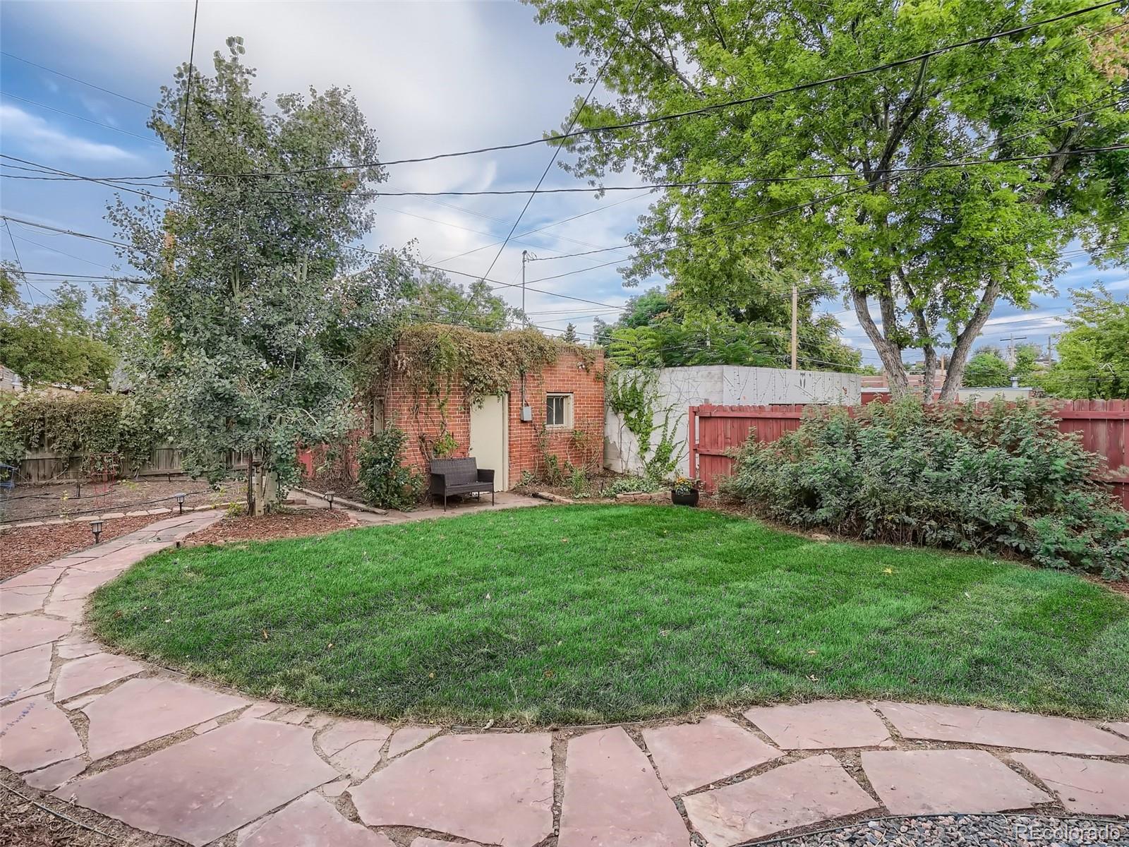 2958 Hooker Street Denver, CO 80211 - Photo 30 of 40 a backyard of a house with plants and large trees
