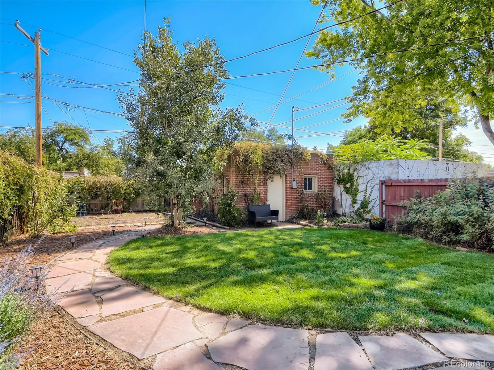 2958 Hooker Street Denver, CO 80211 - Photo 31 of 40 a yellow house with trees in front of it