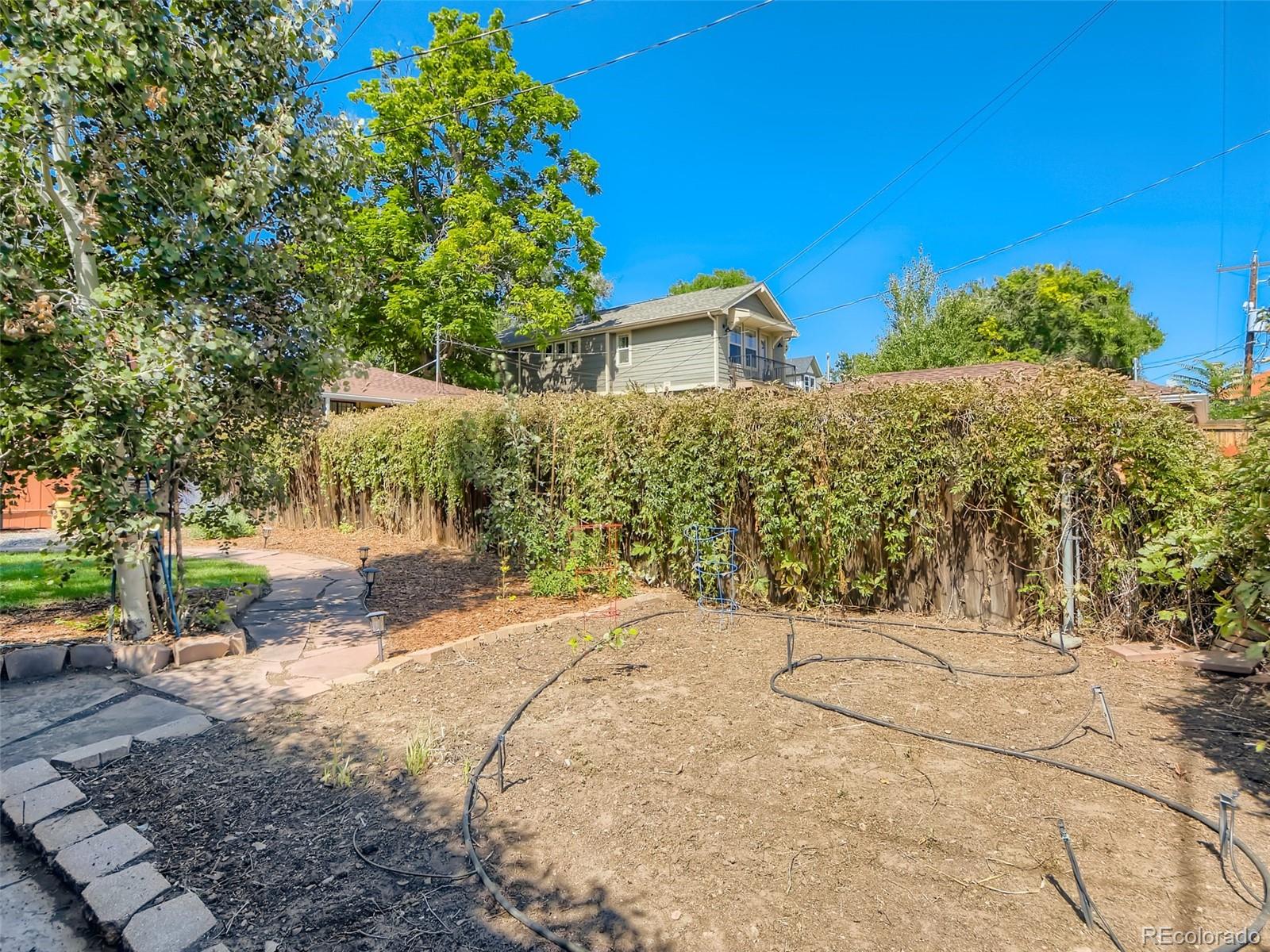 2958 Hooker Street Denver, CO 80211 - Photo 32 of 40 a view of a house with a tree and a yard