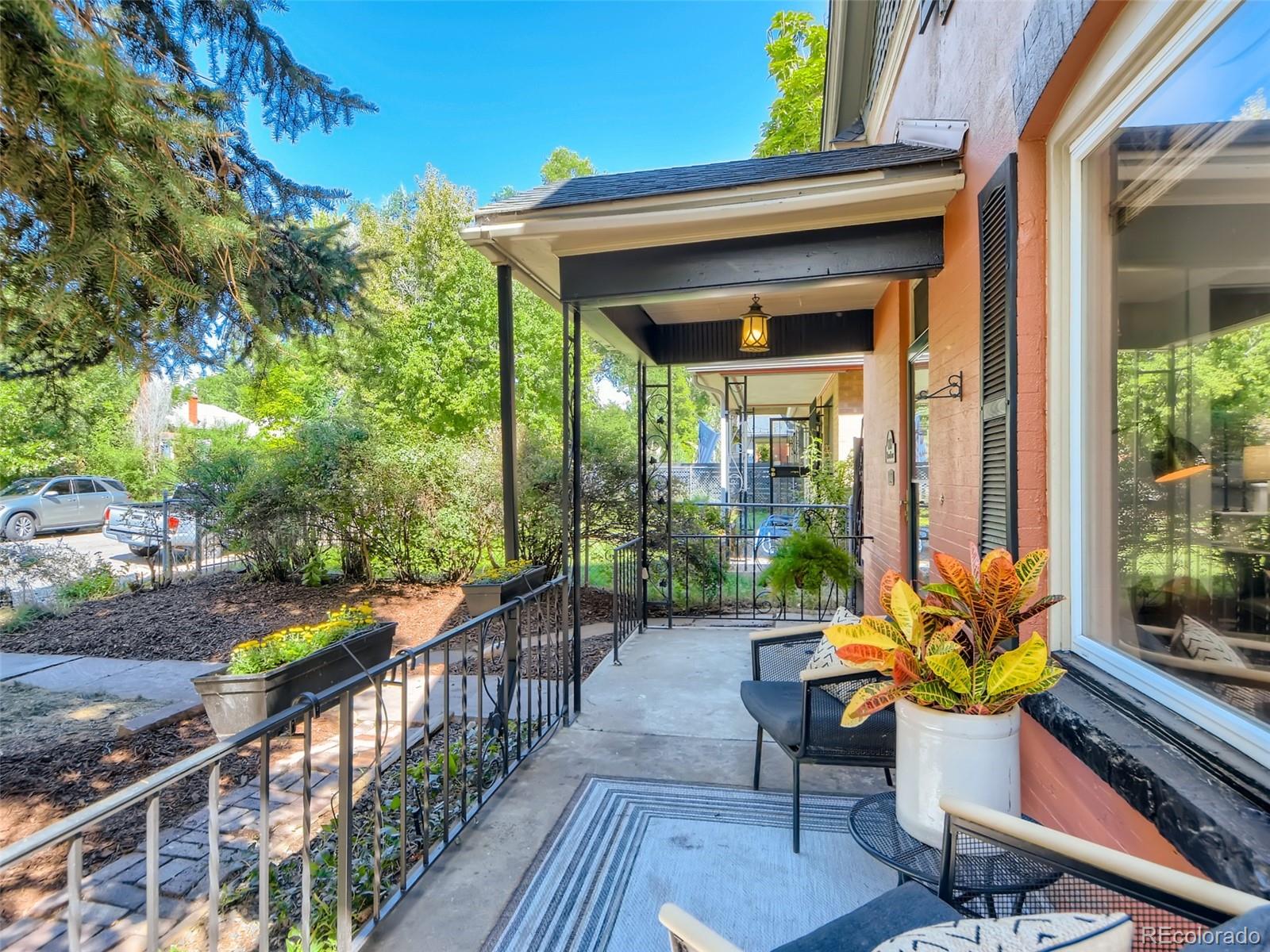 2958 Hooker Street Denver, CO 80211 - Photo 4 of 40 a view of a porch with chairs and wooden fence
