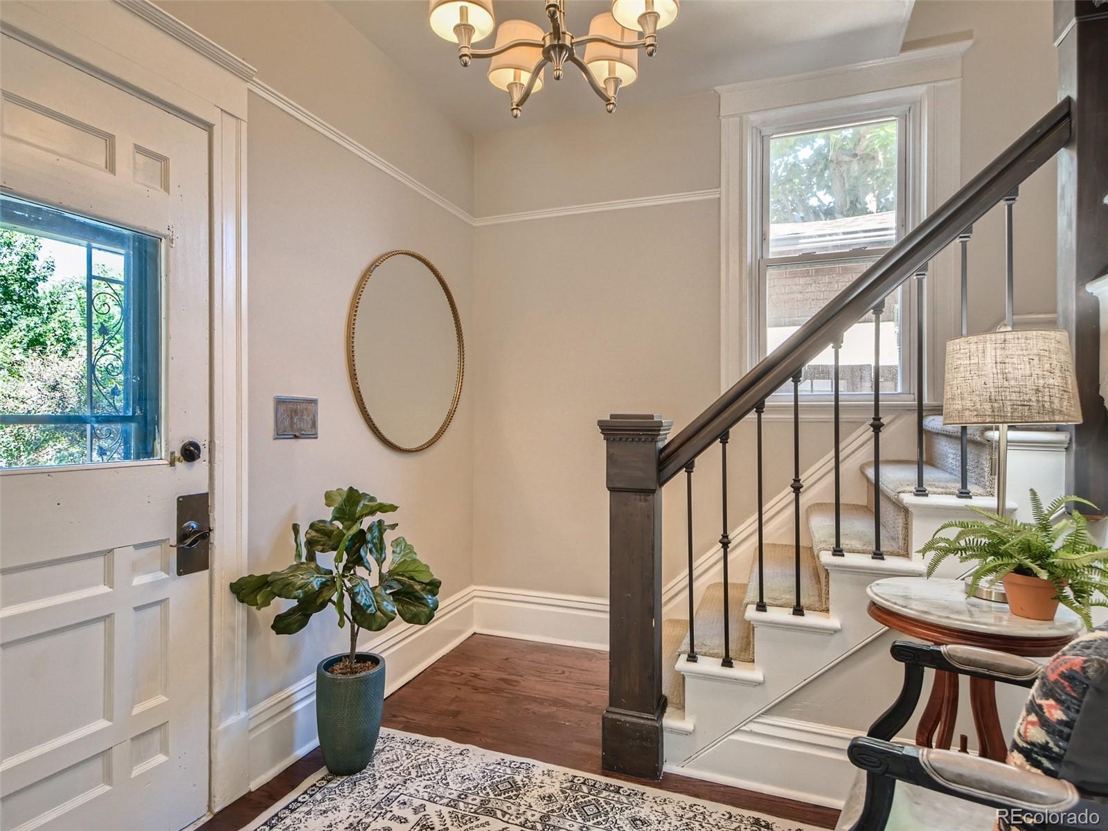 2958 Hooker Street Denver, CO 80211 - Photo 8 of 40 a view of an entryway with wooden floor and a potted plant