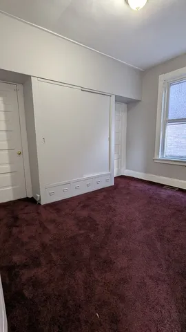 an empty room with an empty space and windows