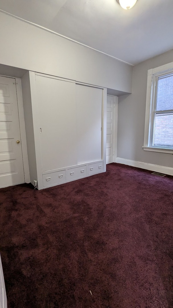 8817 South Elizabeth Street Chicago, IL 60620 - Photo 14 of 17 an empty room with an empty space and windows