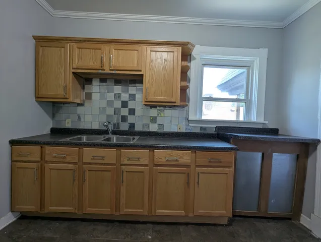a kitchen with cabinets and window