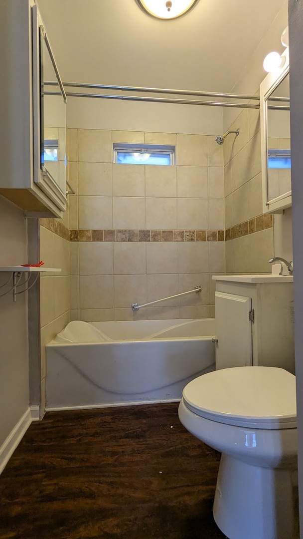 8817 South Elizabeth Street Chicago, IL 60620 - Photo 5 of 17 a bathroom with a toilet and a shower