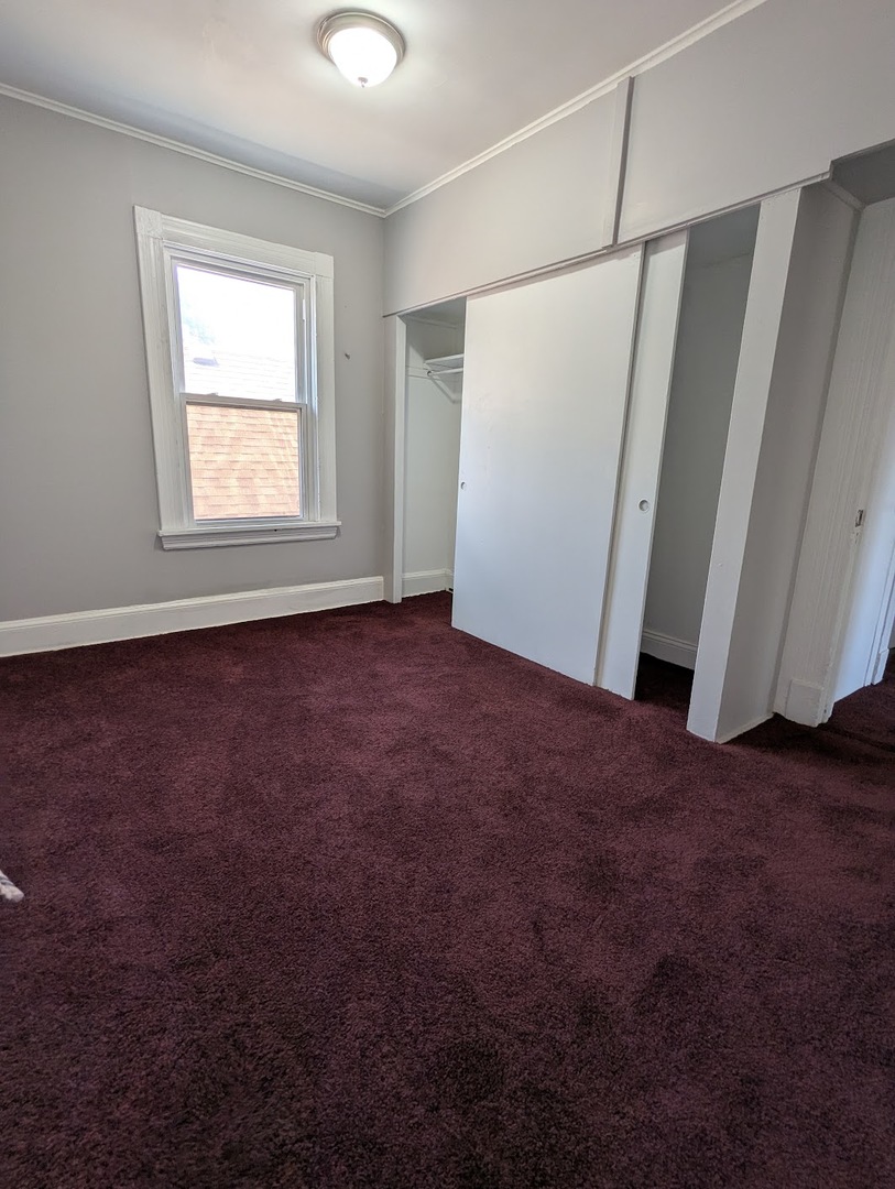 8817 South Elizabeth Street Chicago, IL 60620 - Photo 10 of 17 an empty room with windows