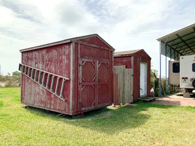 a view of a small wooden house with a small yard