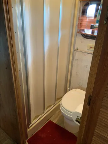 a bathroom with a toilet and a shower