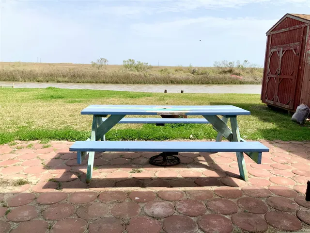 a view of a terrace with a yard and seating space