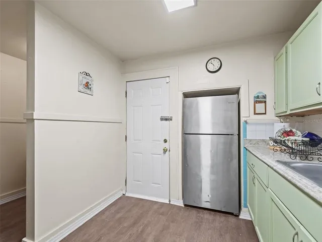 a kitchen with a refrigerator and a microwave