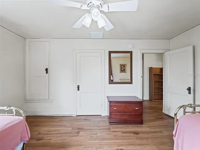 a room with a bed and a dresser