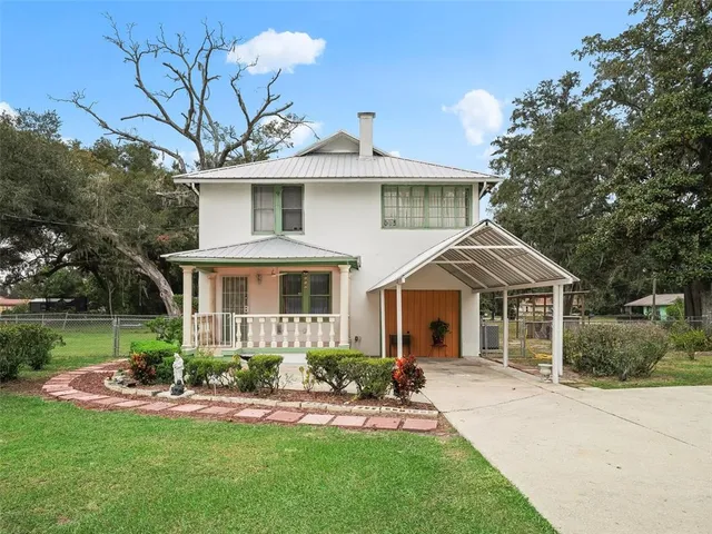 a front view of a house with a yard and porch