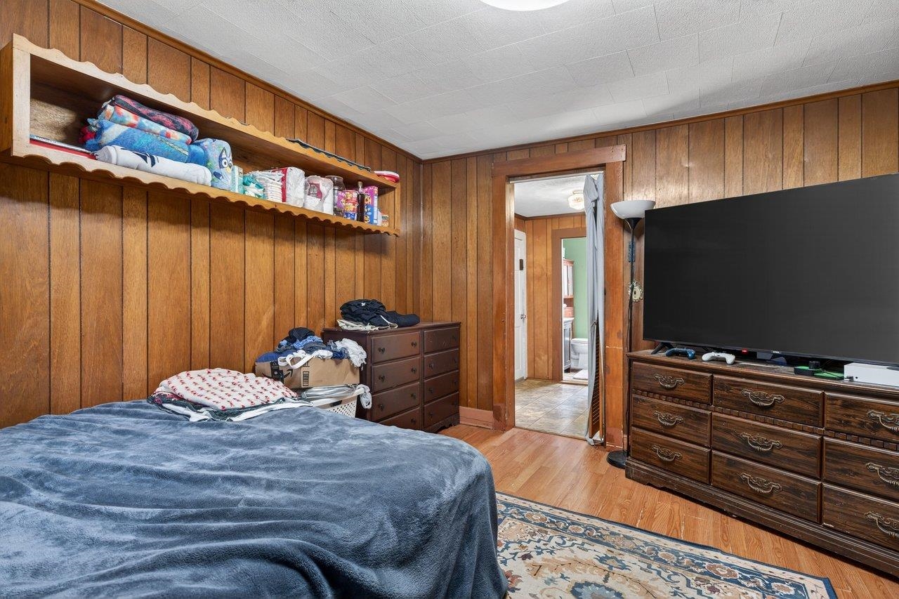 724 Newtown Road Elkton, VA 22827 - Photo 21 of 38 a bedroom with a bed and a flat screen tv
