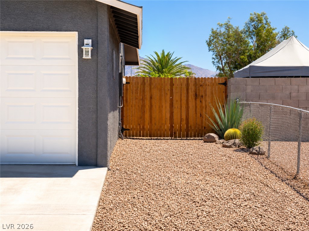 2870 South Sandhill Road Las Vegas, NV 89121 - Photo 3 of 64 A well-maintained side yard features a gravel ground, wood fence, and diverse desert plantings.