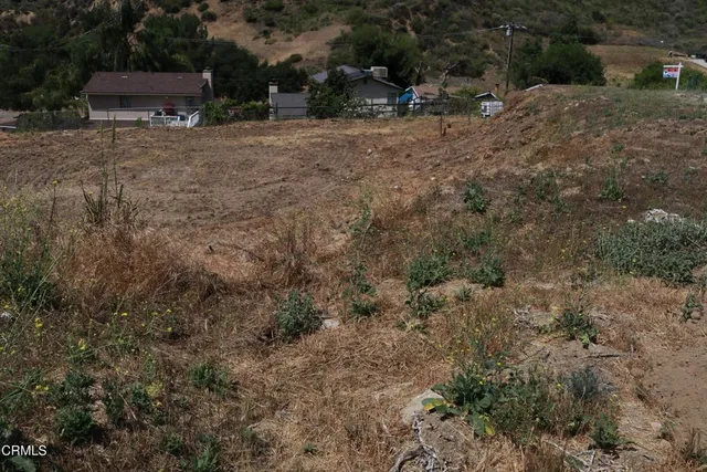 a backyard of a house with barbeque oven and outdoor seating